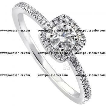 entourage ring with a central brilliant cut diamond with a cushion shaped entourage with castle set diamonds