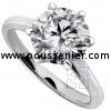 solitaire ring with a brilliant cut diamond on a thinner band with palmets