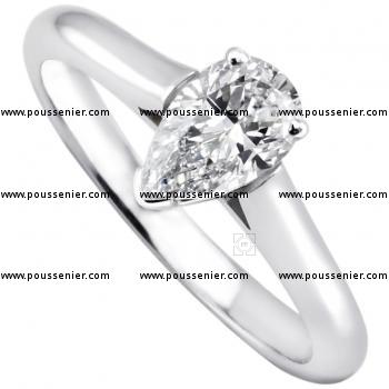 solitaire ring with a pear shaped diamond set in prongs between a band with palmettes