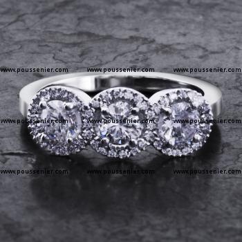 entourage trilogy ring with three central diamonds surrounded with brilliant cut diamonds