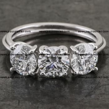 handgemaakte trilogy ring met drie briljant geslepen diamanten gezet in bollige V-vormige griffen opgebouwd met ronde draad aansluitend aan een draadscheen of draadcorps bestaande uit drie draden
