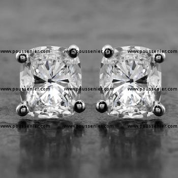 solitaire earrings with cushion cut diamonds set in four rounded curved prongs or claws