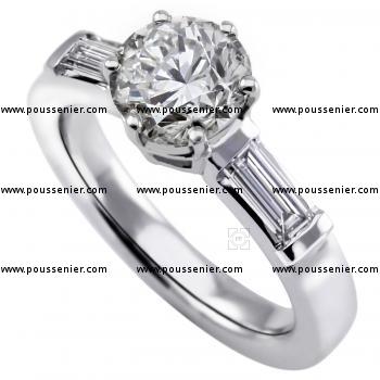 ring with a central brilliant cut diamond with two baguet shaped diamonds on the side