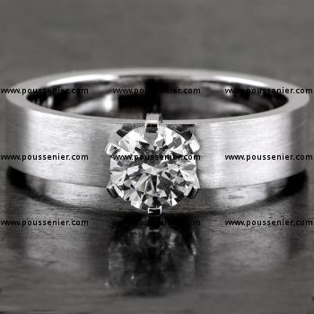 handmade solitaire ring with a brilliant cut diamond set with six prongs on a smooth sanded band with a rectangular profile