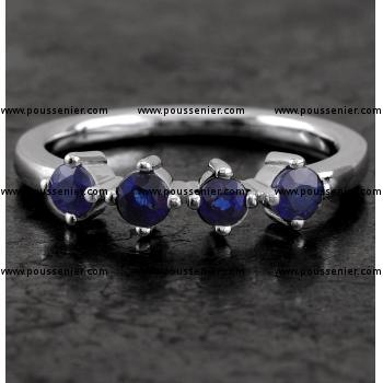 alliance ring with four sapphires zet with four prongs on a sleek thin band with rectangular profile