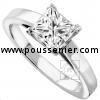 solitaire ring with a princess cut diamond set in a setting with four square cornered prongs on a slim band with palmets