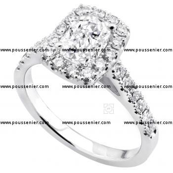halo ring with a central cushion cut diamond surrounded by smaller brilliant cut diamonds on the band with palmettes.