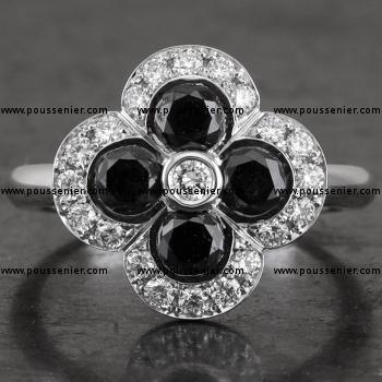 entourage or halo flower ring with four larger black brilliant cut diamonds surrounded by smaller brilliant cut diamonds on a simple band 