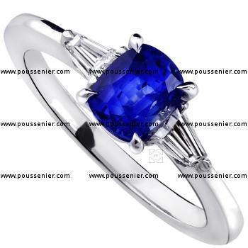ring with a cushion cut sapphire and two tapered cut diamonds on the side mounted on a thinner band