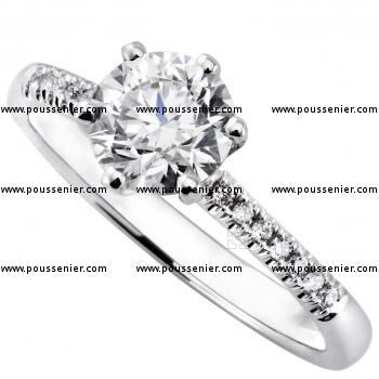 solitaire ring with a brilliant cut diamond set in 6 prongs tiffany setting with castle set smaller diamonds on the side