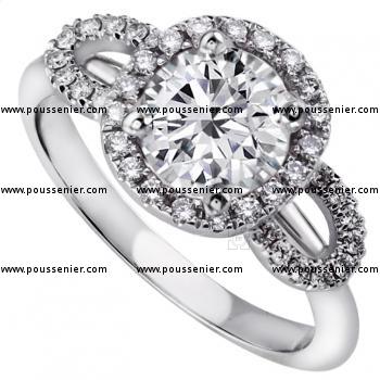 entourage ring with a central brilliant cut diamond with an entourage of castle set diamonds flanked by two arcs