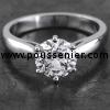 solitaire or engagement ring with a brilliant cut diamond set with six prongs finished with rounded claws mounted between a band with low downward bent arches narrowing like a drop to the diamond