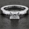 solitaire ring with a princess cut diamond set in a tight square and slighlty higher setting mounted between a slightly smaller band