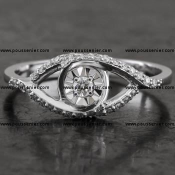 ring with a central brilliant cut diamond in a mirror setting and smaller brilliant cut diamonds on the embracing band