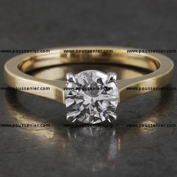 handmade solitaire ring with a brilliant cut diamond set into four slightly roundned prongs on a band with palmets (wearable together with wedding band)