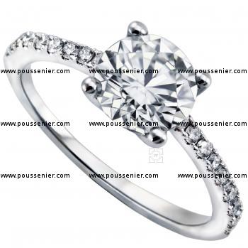 solitaire ring with a central brilliant cut diamond with smaller diamonds on the side castelsetted a finer band