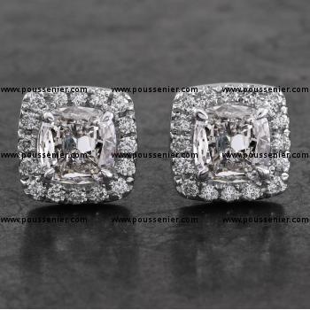 halo entourage earrings with central cushion cut diamonds surrounded by smaller castle-set brilliants 