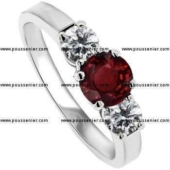 trilogy ring with a central ruby and brilliant cut diamonds wtih 3 prongs for the stones on the side