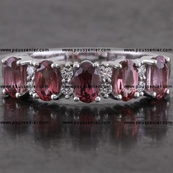 ring with brilliant cut diamonds set with three prongs and oval rhodolite set with four prongs