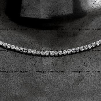 Tennis necklace or rivière with brilliant-cut diamonds set in prongs, finished with a Franco chain featuring tightly woven square or V-shaped links.