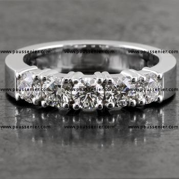 alliance ring with five larger brilliant cut diamonds set with four prongs mounted on a sturdy band with a rectangular profile 