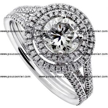 double halo ring with a larger brilliant cut diamond surrounded by smaller castle set brilliants