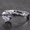 handmade solitaire ring with a brilliant cut diamond in a twisted setting with four claws lozange on the slightly rounded band that extends like a prong on the furthest side of the same side