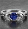 handmade soltaire ring with a brilliant cut sapphire along which small marquise shaped leaves decorated with diamonds