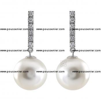 pearl earrings with round white South Sea pearls moving on a row of six brilliant cut diamonds set with prongs