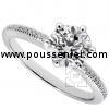 solitaire ring with a central brilliant in six prongs on a thinner band castle set with smaller brilliants