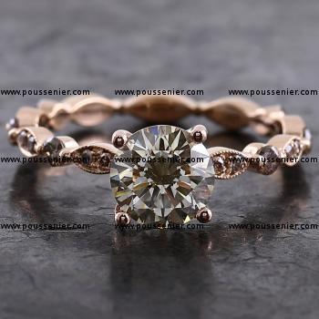 alliance ring with a larger olive greenish brown diamond set on a band with marquee pavé set with brown brilliants finished with millegraine and alternated with diamonds set with two claws