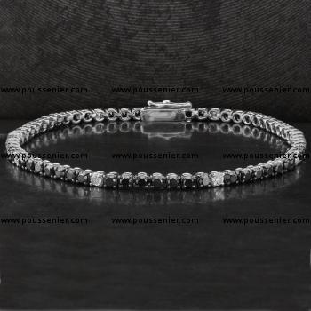 tennis bracelet or rivière set with white and black brilliant cut diamonds in prong chatons set with four claws