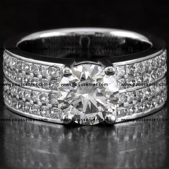 solitaire ring with a larger central brilliant cut diamond flanked by four rows of princess cut diamonds on a slim wide band