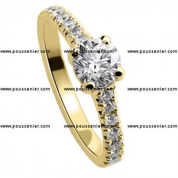 solitaire ring with a brilliant cut diamond and smaller castle set diamonds on the side