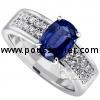 ring with a cushion cut sapphire set in four prongs between a band pavé set with two rows of brilliant-cut diamonds