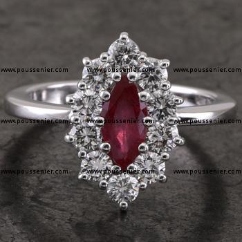 entourage ring with a central marquise-cut ruby surrounded by brilliant-cut diamonds set with prongs mounted low between a band with rectangular rounded profile 
