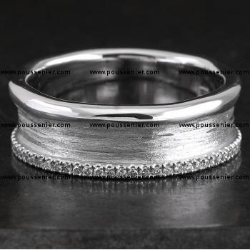 wide wedding band with organic polished edges and a straight edge castle set with brilliant cut diamonds