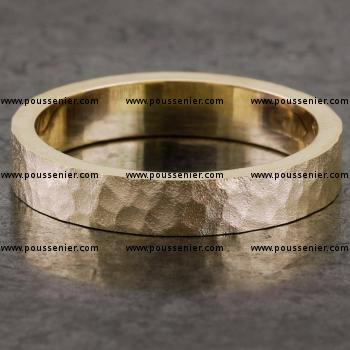 wedding ring handmade with a rectangular profile and the top treated with a convex hammer
