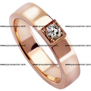 solitaire ring with a rectangular profile set with a brilliant cut diamond set in a samll block with four grains