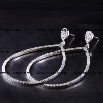 earrings with pear shaped with brilliant cut diamonds castle set dangling on a smaller drop shaped part