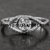 ring with a central brilliant cut diamond in a mirror setting and smaller brilliant cut diamonds on the embracing band