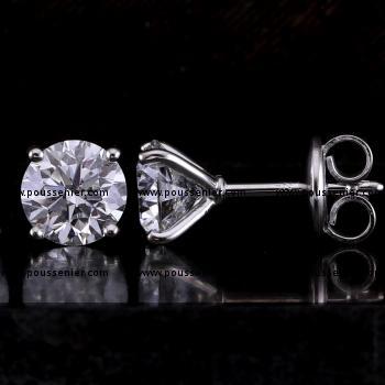 solitaire earrings with brilliant cut diamonds set with four prongs in a martini setting