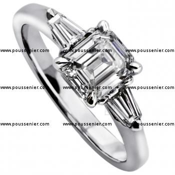 handmade ring with an emerald cut diamond flanked by 2 tapers on a smaller band