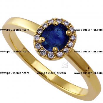 entourage ring with an oval sapphire surrounded by brilliant cut diamonds on top of a flatter unset band