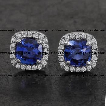 halo earrings with central cushion cut heat treated sapphires surrounded by brilliant cut diamonds