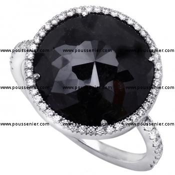 halo ring with a Tambuli cut color enhanced Black diamond of 5.77ct surrounded by white brilliant cut diamonds