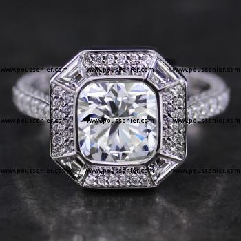 double halo ring with a cushion cut diamond bezel set and surrounded by four trapees cut and pavé set diamonds on a single band pavé set with three rows of smaller diamonds