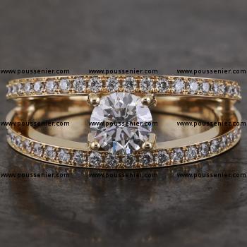 solitaire ring with a central brilliant cut diamond mounted between two lower pavé-set bands