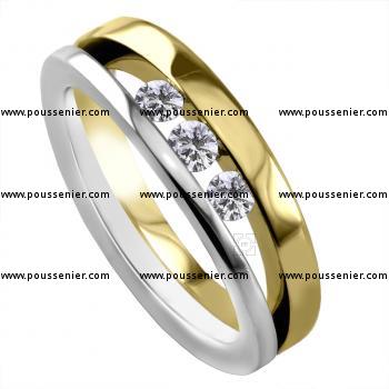 wedding ring with three brilliant cut diamonds chanel set between two bands