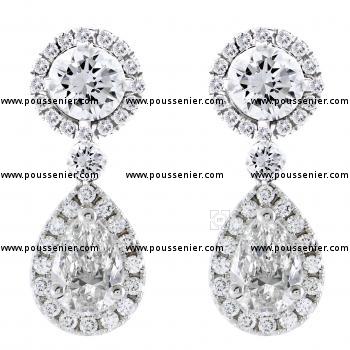 earrings with large brilliant cut diamonds under which a pear-cut diamond all surrounded by smaller brilliant-cut diamonds